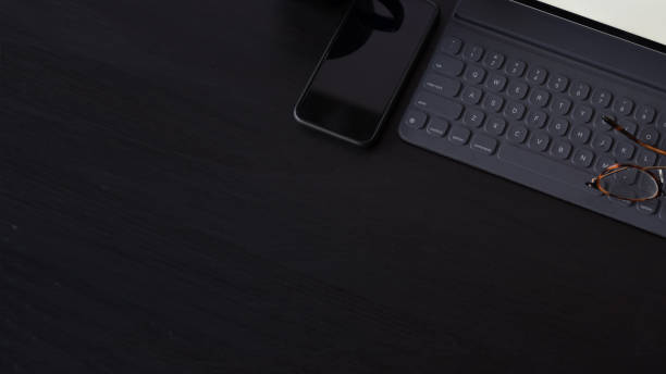 istock Business Items tablet, pen, mobile phone  on dark wood workspace table and copy space 1147442048