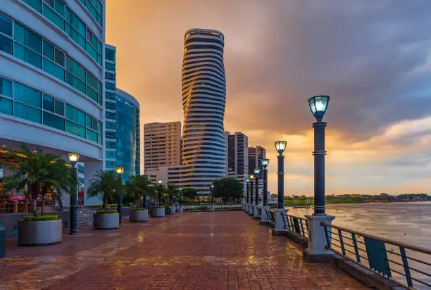 Cityscape of Guayaquil city at sunset with a view over the Malecon 2000 waterfront, the Guayas river and the point skyscraper after a thunderstorm, Ecuador.