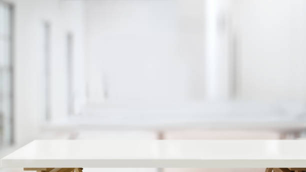 istock White wood tabletop and blurred bokeh office interior space background 1147442342