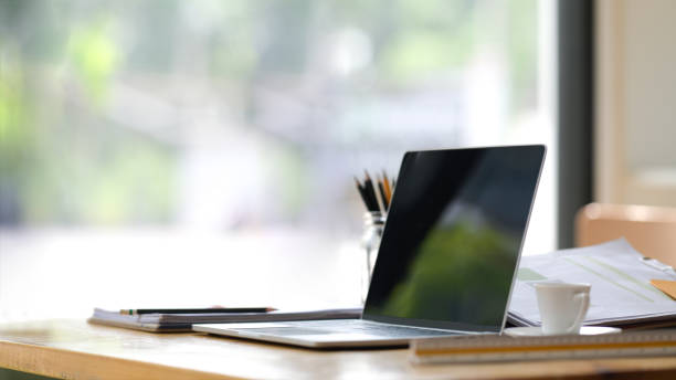 istock Workplace in office room with open laptop, office supplies. 1147443160