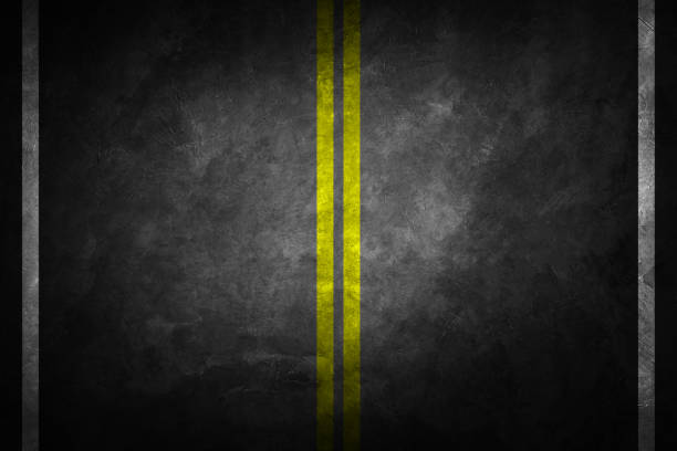 istock Structure of granular asphalt. Asphalt texture with two yellow line road marking. Abstract road background. 1147443363