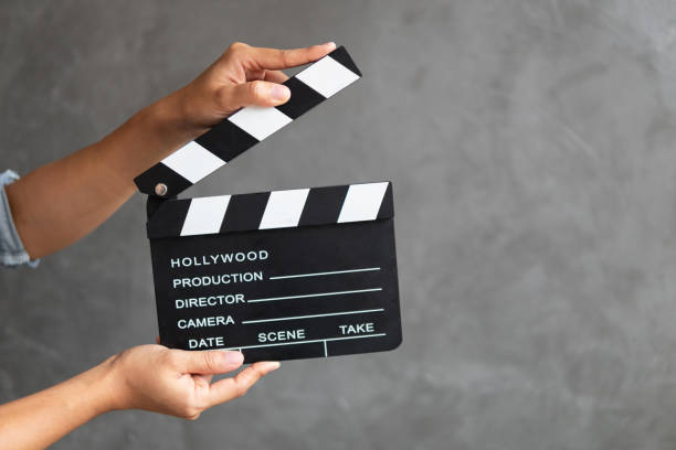 istock Women hands holding clapper board for making video cinema in studio. 1147443455