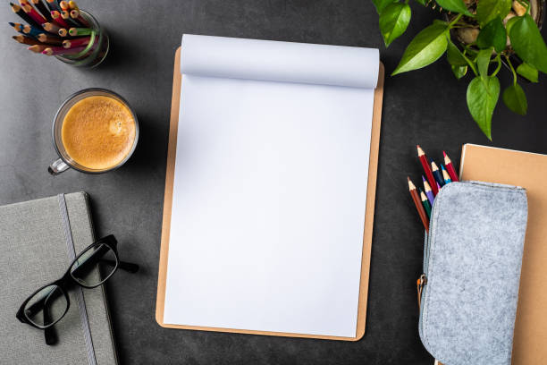 istock white paper with clipboard on black background 1147445397