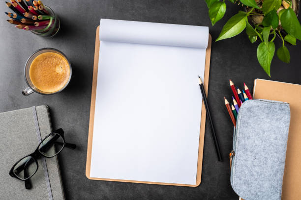 istock white paper with clipboard on black background 1147445413