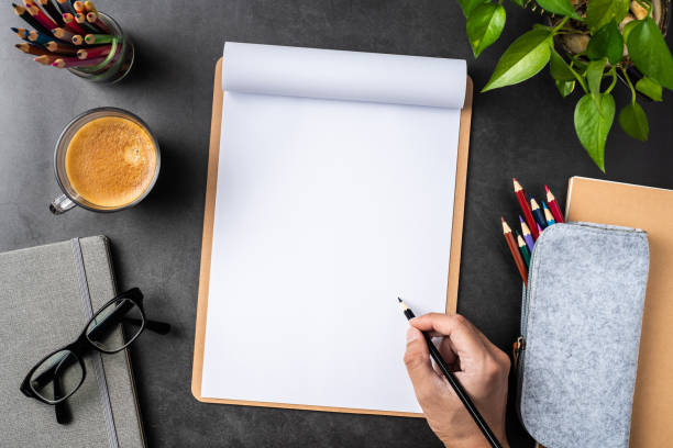 istock white paper with clipboard on black background 1147445423