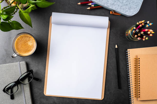 istock white paper with clipboard on black background 1147445451
