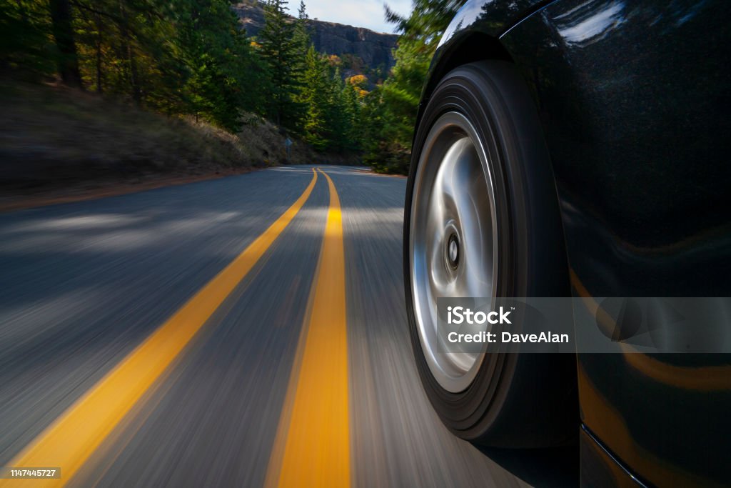 Black sports car motion country road. A black sports car on a country road in Oregon. Car Stock Photo