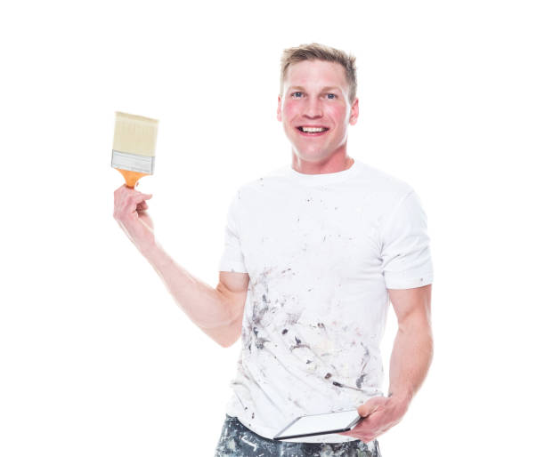 istock Very good looking young white painter on white background - holding tablet 1147451632