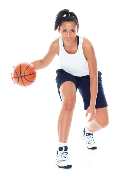 Attractive African American female playing basketball - fotografia de stock
