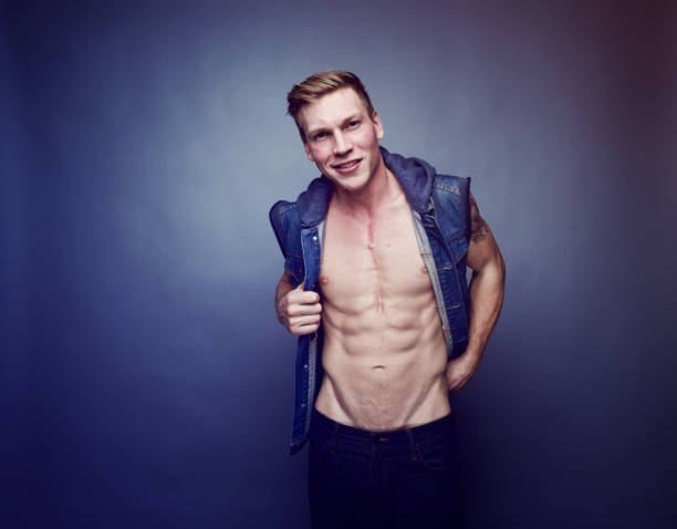 Handsome man wearing a vest and showing off his abs Handsome man wearing a vest and showing off his abs 18797 stock pictures, royalty-free photos & images