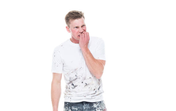 istock Young attractive male painter standing on white background - emotional stress 1147458380