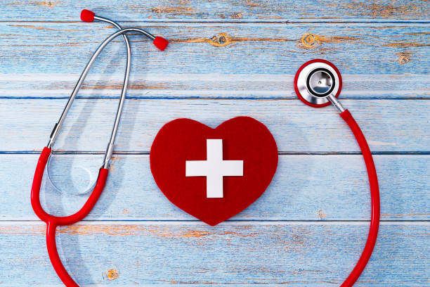 istock World Red Cross day. Red heart with Stethoscope on wooden table background 1147462821