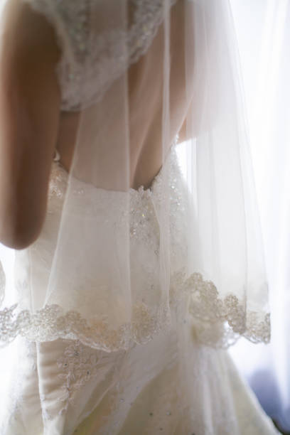 vue arrière d’une mariée dans la robe de mariage avec le voile - wedding dress wedding domestic room bride photos et images de collection