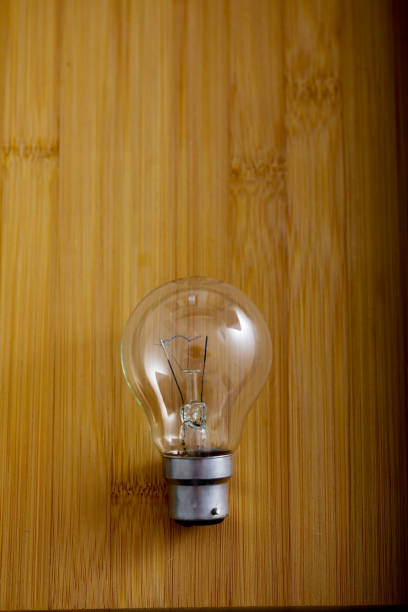 istock bulb with green leaf on wooden background 1147467084