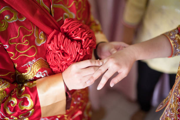 istock Bridegroom putting on the wedding ring for the bride 1147467154