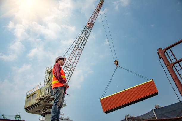 takes loading in control engineering, loading master takes control loading with gantry crane for lifting safety operation in loading the goods or shipment at job site, working with industrial and heavy lift hoisting photos stock pictures, royalty-free photos & images