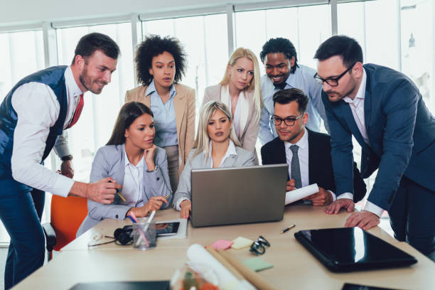 istock Group of young business people working together in creative office. 1147474756