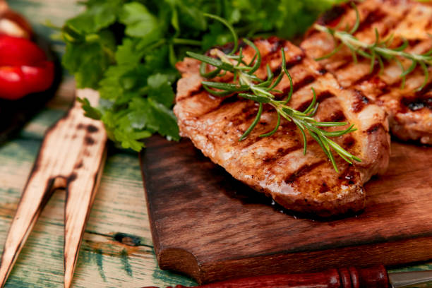 istock Steak pork grill on wooden cutting board 1147475068