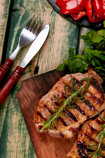 istock Steak pork grill on wooden cutting board 1147475091