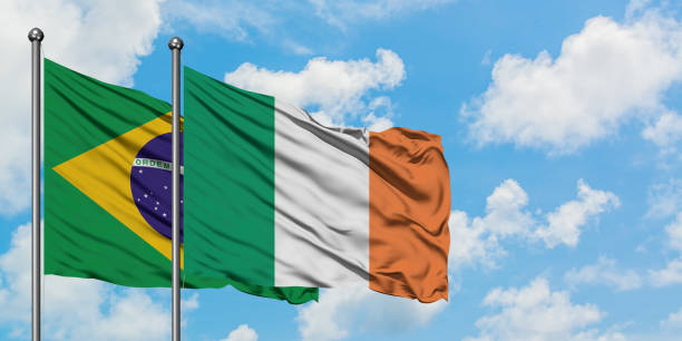 Brazil and Ireland flag waving in the wind against white cloudy blue sky together. Diplomacy concept, international relations. Brazil and Ireland flag waving in the wind against white cloudy blue sky together. Diplomacy concept, international relations. consul photos stock pictures, royalty-free photos & images
