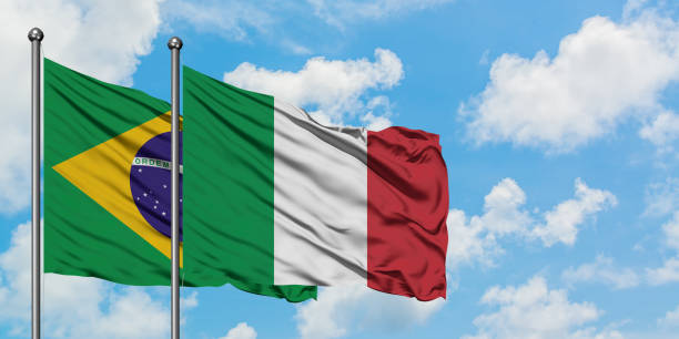Brazil and Italy flag waving in the wind against white cloudy blue sky together. Diplomacy concept, international relations. Brazil and Italy flag waving in the wind against white cloudy blue sky together. Diplomacy concept, international relations. consul photos stock pictures, royalty-free photos & images