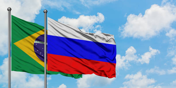 Brazil and Russia flag waving in the wind against white cloudy blue sky together. Diplomacy concept, international relations. Brazil and Russia flag waving in the wind against white cloudy blue sky together. Diplomacy concept, international relations. consul photos stock pictures, royalty-free photos & images