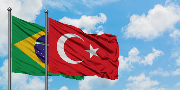 Brazil and Turkey flag waving in the wind against white cloudy blue sky together. Diplomacy concept, international relations. Brazil and Turkey flag waving in the wind against white cloudy blue sky together. Diplomacy concept, international relations. consul photos stock pictures, royalty-free photos & images