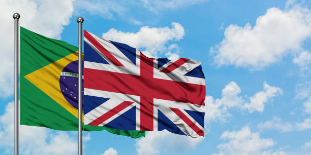 Brazil and United Kingdom flag waving in the wind against white cloudy blue sky together. Diplomacy concept, international relations. Brazil and United Kingdom flag waving in the wind against white cloudy blue sky together. Diplomacy concept, international relations. consul photos stock pictures, royalty-free photos & images