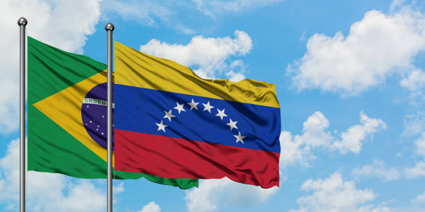Brazil and Venezuela flag waving in the wind against white cloudy blue sky together. Diplomacy concept, international relations. Brazil and Venezuela flag waving in the wind against white cloudy blue sky together. Diplomacy concept, international relations. consul photos stock pictures, royalty-free photos & images