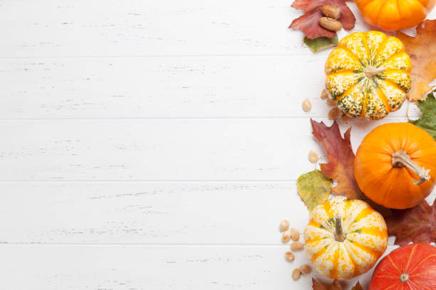 istock Autumn backdrop with pumpkins and colorful leaves 1147478313