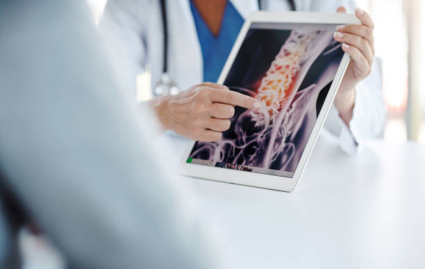 Imaging evaluation is crucial in confirming a diagnosis Shot of a doctor showing her patient his scan on a digital tablet medical x ray stock pictures, royalty-free photos & images