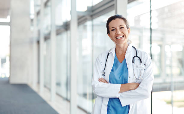 It brings me joy to help others Shot of a female doctor standing confidently with her arms crossed female doctor photos stock pictures, royalty-free photos & images