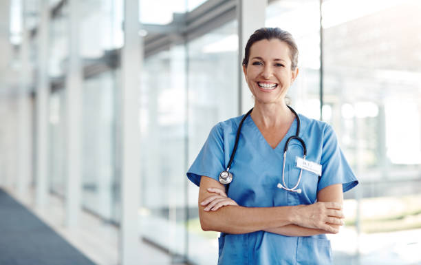 The best part about my job is saving lives Shot of a female nurse standing confidently with her arms crossed medical scrubs stock pictures, royalty-free photos & images