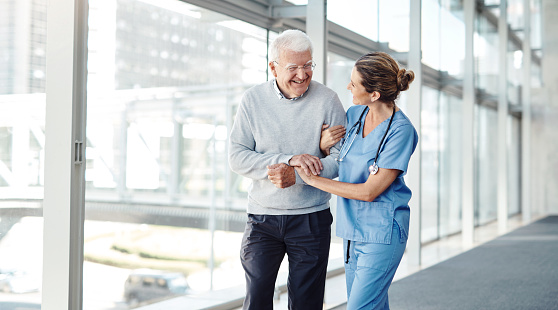 Shot of a female nurse assisting her senior patient while walking