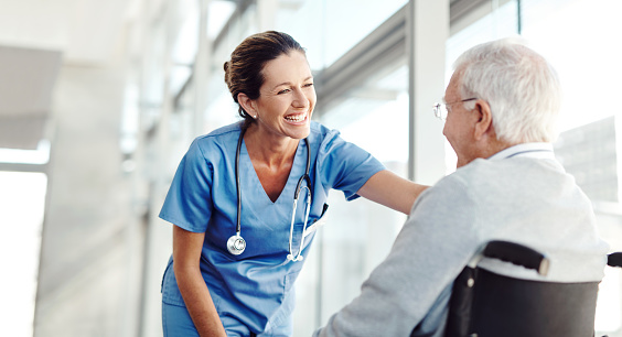 Shot of a senior man in a wheelchair with a female nurse