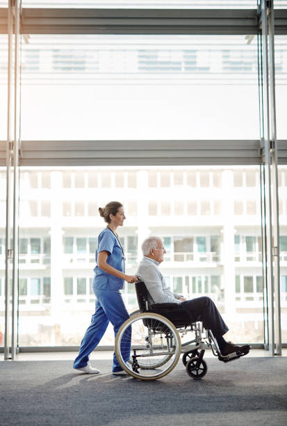 off to his physio - senior adult hospital uniform gray hair imagens e fotografias de stock