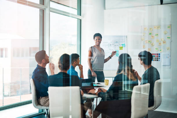 Growth creates more growth Shot of a group of businesspeople having a meeting in a modern office whiteboard visual aid photos stock pictures, royalty-free photos & images