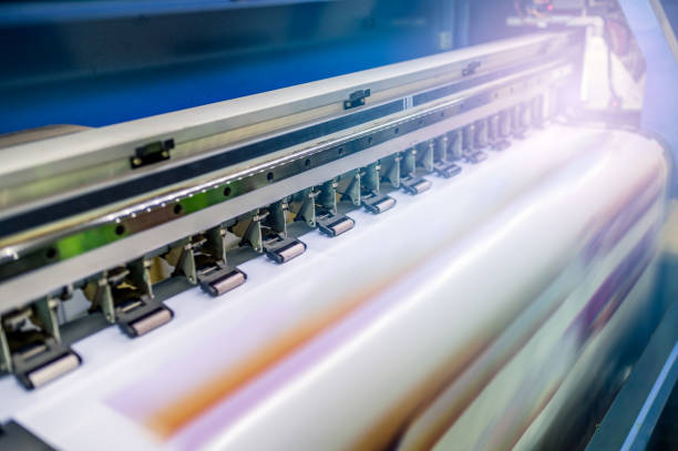 istock Large inkjet printer with printing on vinyl paper with lighting 1147479816