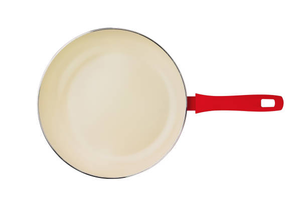 istock One empty red aluminum deep fry pan with non-stick beige coating and plastic handle isolated on white background. Top view 1147486262
