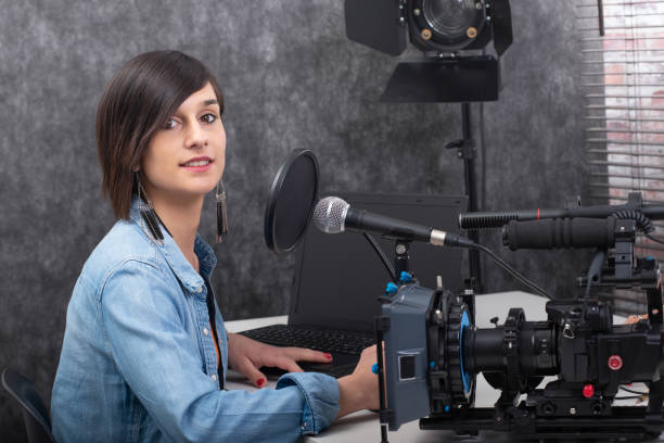 istock Young brunette woman video editor working in studio 1147489357