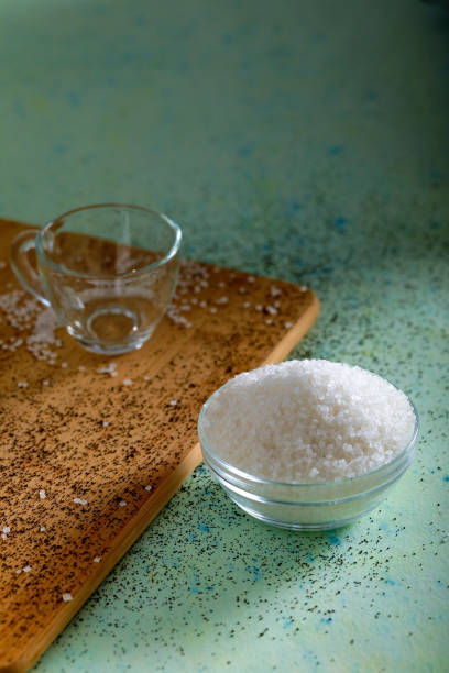 istock Sugar in glass bowl on wooden background 1147489434