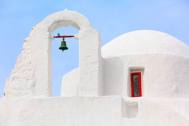 White Paraportiani Church on the island of Mykonos, Greece close-up bell tower with blue sky background
