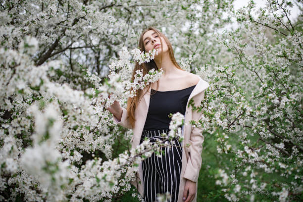 istock A young woman has relax among the blossoming cherry trees. 1147494391