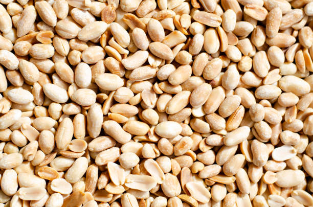 istock Background with lots of peeled peanuts. 1147494549