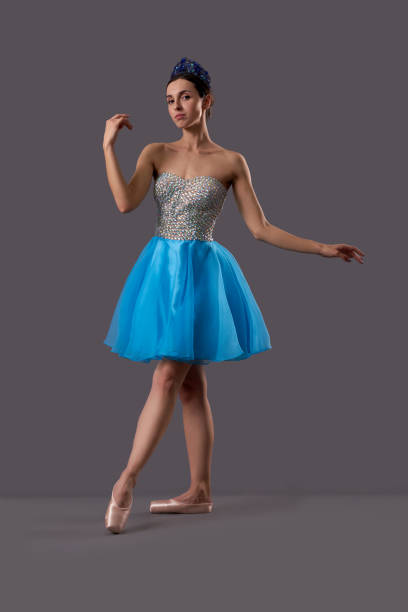 istock Ballerina wearing blue dress posing in studio 1147495896