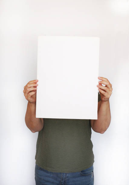 istock woman's hands holding white paper poster on white background 1147498045