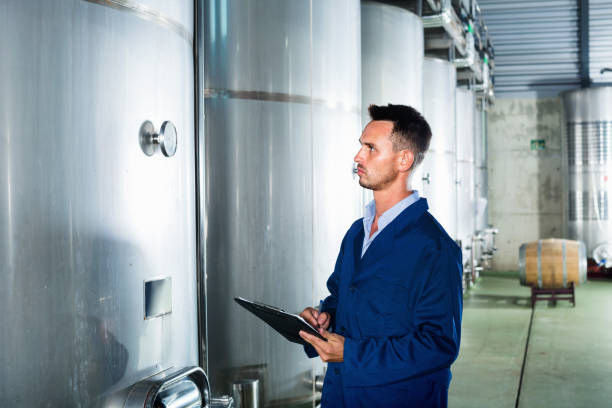 istock Portrait of  man wearing coat taking off data from equipment 1147498781