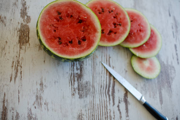 istock Slices of watermelon on wooden table 1147503331