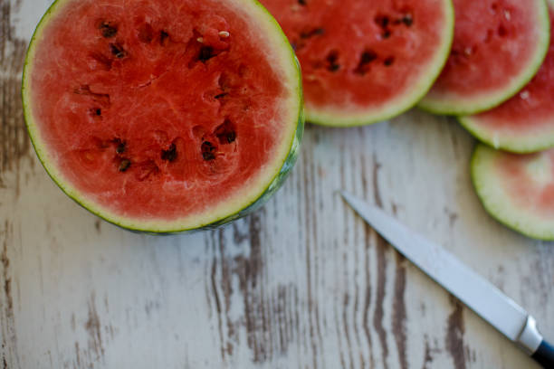 istock Slices of watermelon on wooden table 1147503348