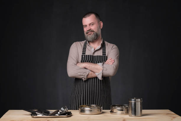 istock Bearded male chef showing different spices he uses. 1147503542